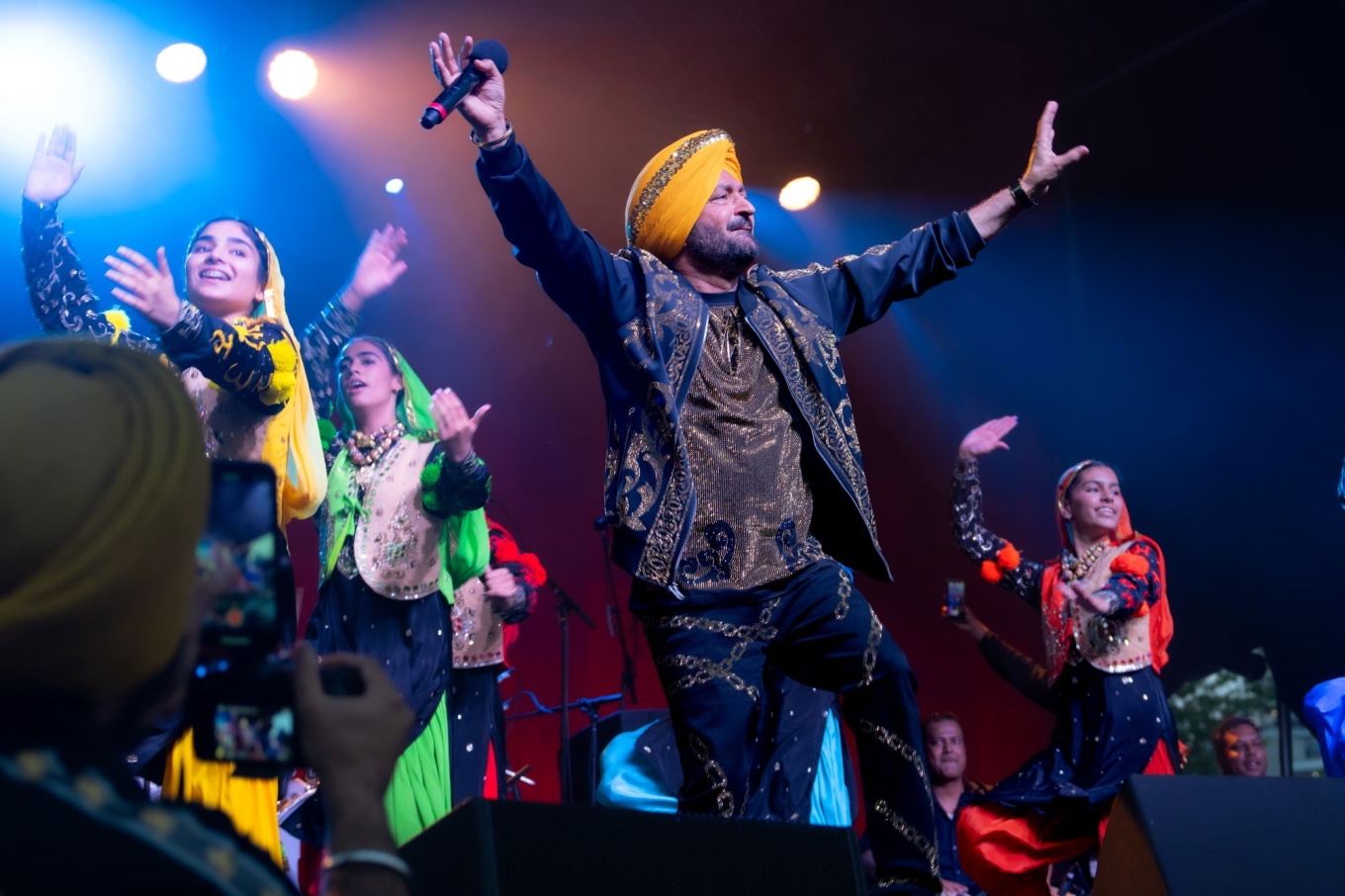 Malkit Singh and background dancers.